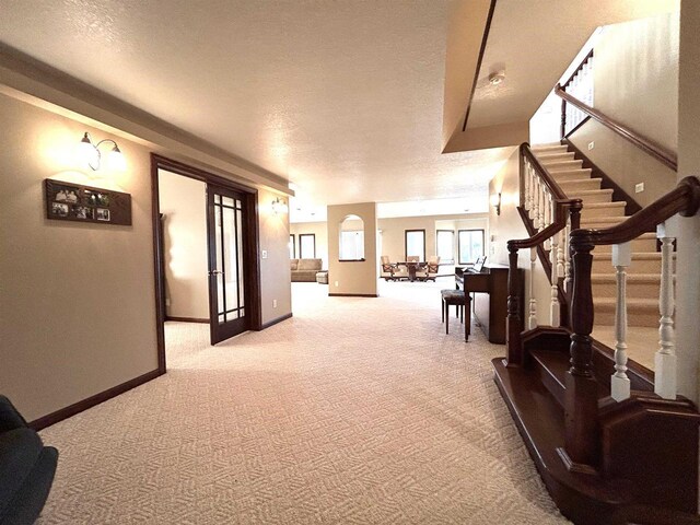 25621 Honeycut Ave, Tomah, WI 54660 - interior space with light carpet, baseboards, stairs, and a textured ceiling