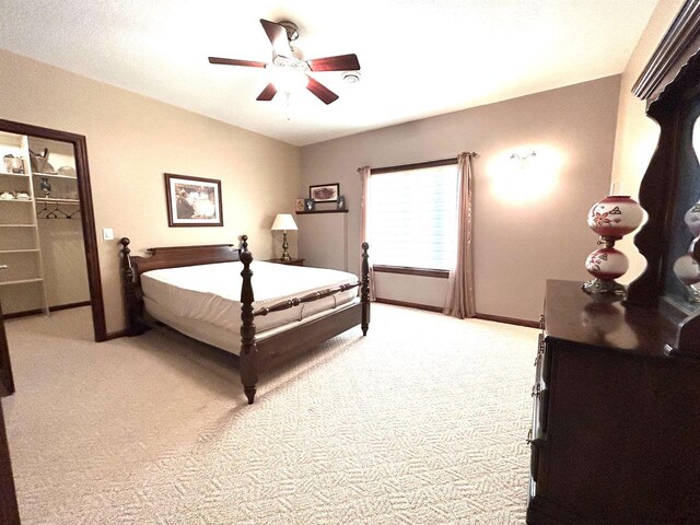 25621 Honeycut Ave, Tomah, WI 54660 - bedroom with baseboards, ceiling fan, a walk in closet, and light carpet