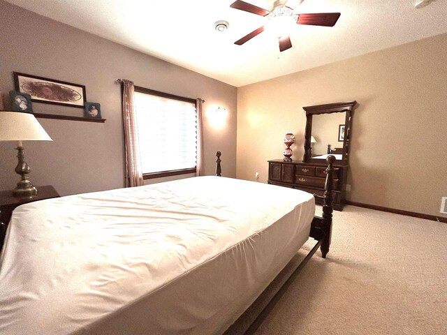 25621 Honeycut Ave, Tomah, WI 54660 - bedroom featuring baseboards, a ceiling fan, and light carpet