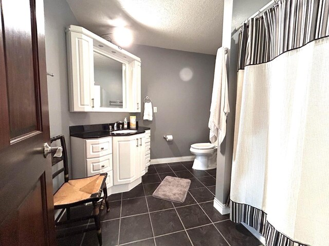 25621 Honeycut Ave, Tomah, WI 54660 - full bathroom with a textured ceiling, baseboards, toilet, tile patterned floors, and vanity