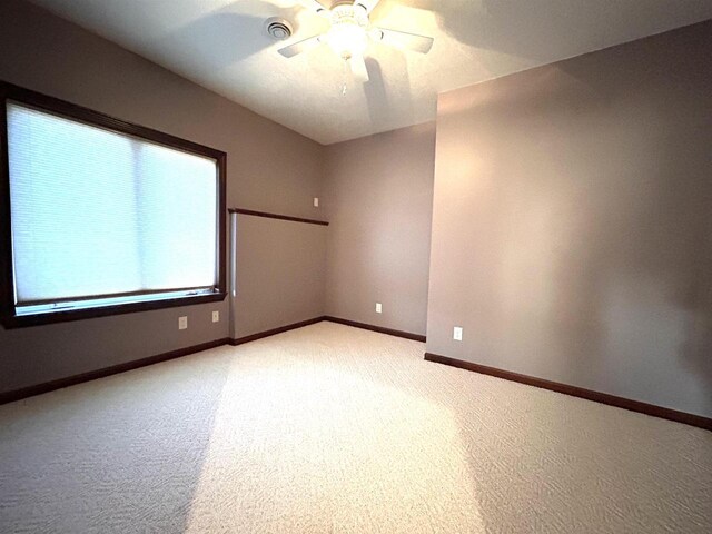 25621 Honeycut Ave, Tomah, WI 54660 - spare room with light carpet, baseboards, visible vents, and ceiling fan