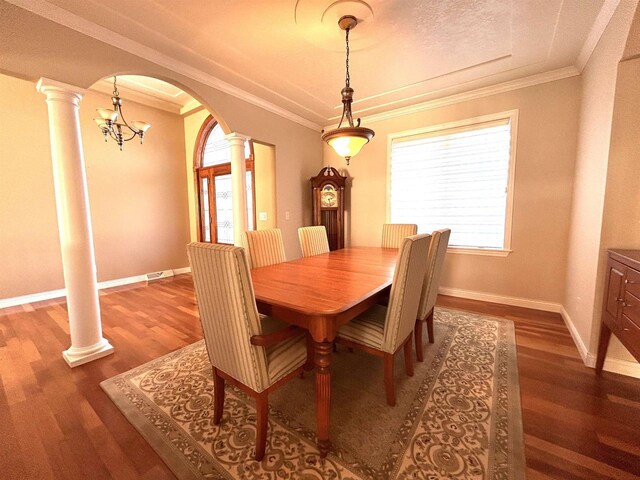 25621 Honeycut Ave, Tomah, WI 54660 - dining space featuring wood finished floors, ornate columns, arched walkways, ornamental molding, and a healthy amount of sunlight