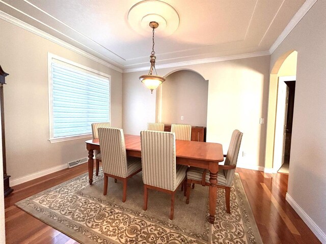 25621 Honeycut Ave, Tomah, WI 54660 - dining space featuring ornamental molding, arched walkways, baseboards, and wood finished floors