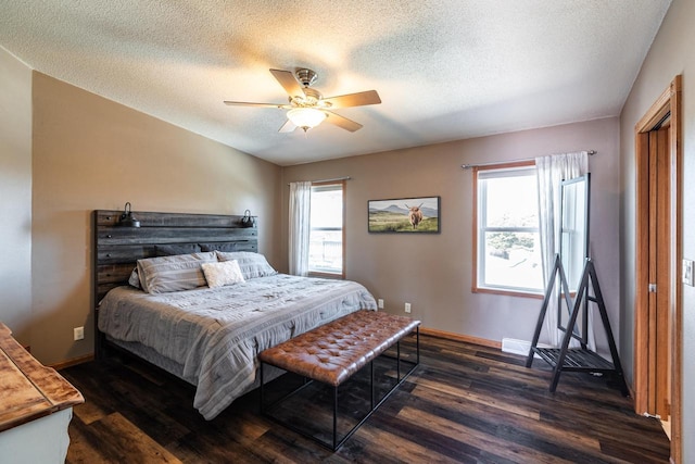 N1179 County Road O, Stoddard, WI 54658 - bedroom featuring baseboards, multiple windows, a textured ceiling, and dark wood finished floors