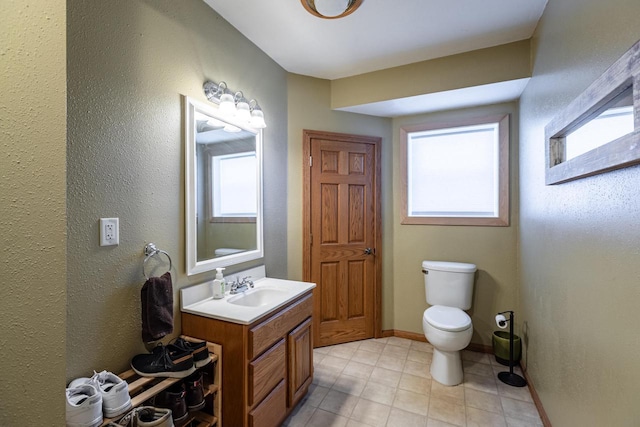 N1179 County Road O, Stoddard, WI 54658 - bathroom featuring toilet, vanity, and baseboards