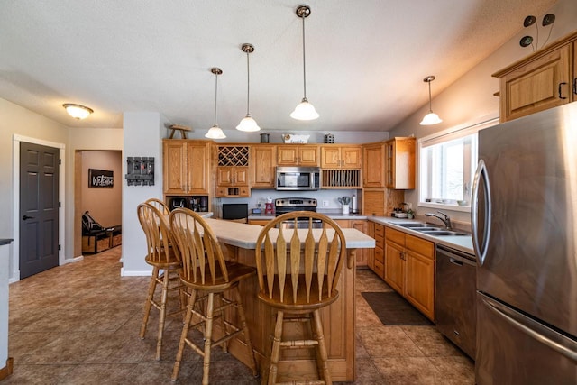 N1179 County Road O, Stoddard, WI 54658 - kitchen with light countertops, a sink, a kitchen breakfast bar, appliances with stainless steel finishes, and a center island
