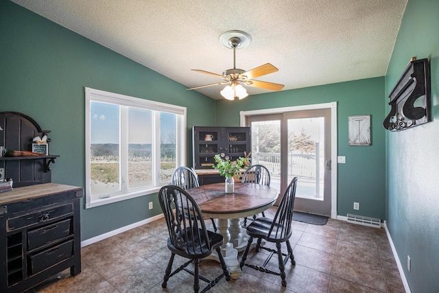 N1179 County Road O, Stoddard, WI 54658 - dining area featuring lofted ceiling, baseboards, a textured ceiling, ceiling fan, and visible vents