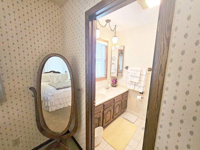 1090 Shabbona Dr, Fontana, WI 53125 - ensuite bathroom with wallpapered walls, tile patterned floors, vanity, and baseboards