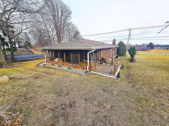1090 Shabbona Dr, Fontana, WI 53125 - rear view of property featuring a chimney, a yard, and covered porch