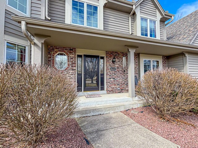view of exterior entry with brick siding
