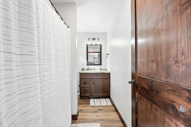 W11490 Boat Landing 7 Rd, Athelstane, WI 54104 - full bathroom featuring baseboards, wood finished floors, and vanity