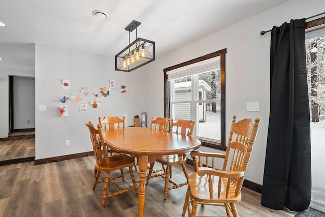 W11490 Boat Landing 7 Rd, Athelstane, WI 54104 - dining area featuring baseboards, an inviting chandelier, and light wood-type flooring