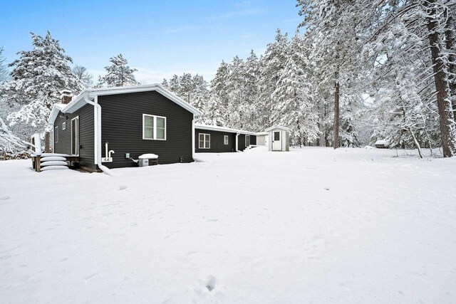 W11490 Boat Landing 7 Rd, Athelstane, WI 54104 - exterior space featuring a chimney, a storage unit, an outdoor structure, and central AC unit