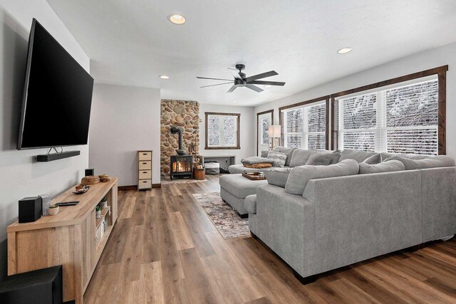 W11490 Boat Landing 7 Rd, Athelstane, WI 54104 - living room with ceiling fan, wood finished floors, a wood stove, and plenty of natural light