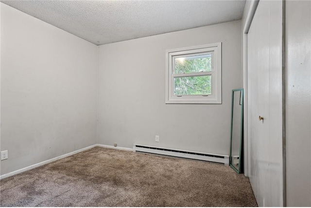 806 Oak Ridge Dr, Osceola, WI 54020 - carpeted empty room with a baseboard radiator, a textured ceiling, and baseboards