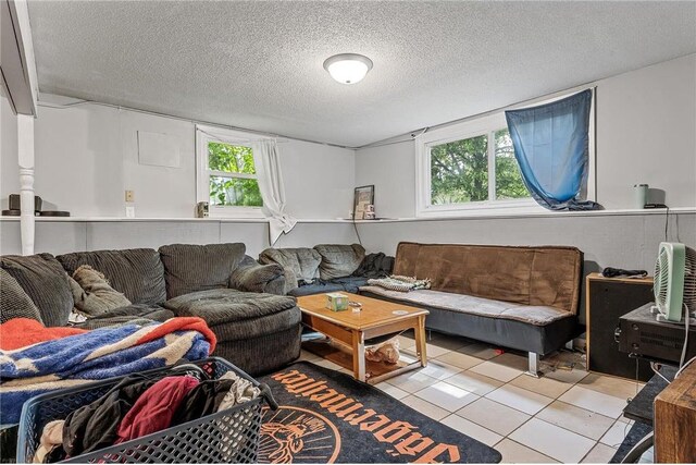 806 Oak Ridge Dr, Osceola, WI 54020 - living room featuring tile patterned floors, plenty of natural light, and a textured ceiling