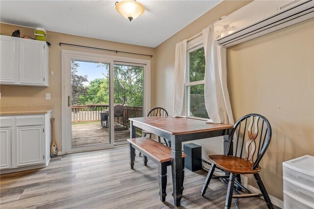 806 Oak Ridge Dr, Osceola, WI 54020 - dining room with a wall mounted air conditioner and light wood-style flooring