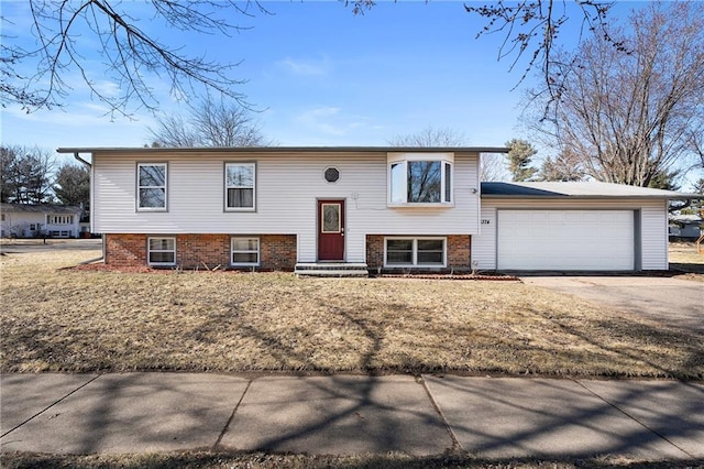 3374 Gerrard Ave, Eau Claire, WI 54701 - raised ranch featuring driveway, a garage, and brick siding