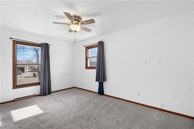 3374 Gerrard Ave, Eau Claire, WI 54701 - carpeted empty room with a ceiling fan, baseboards, and a textured ceiling