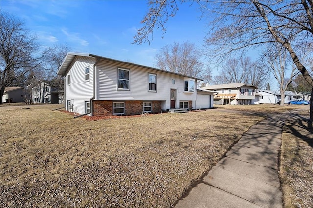 3374 Gerrard Ave, Eau Claire, WI 54701 - back of house with a garage and a yard