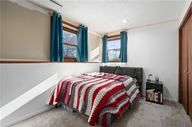 3374 Gerrard Ave, Eau Claire, WI 54701 - carpeted bedroom featuring visible vents, a closet, baseboards, and a textured ceiling