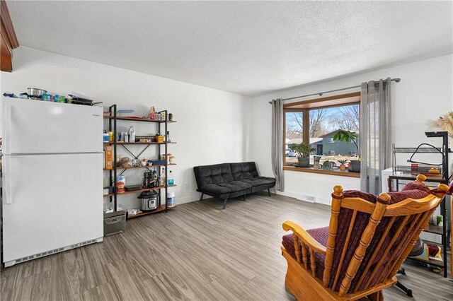 3374 Gerrard Ave, Eau Claire, WI 54701 - living area featuring baseboards, visible vents, wood finished floors, and a textured ceiling