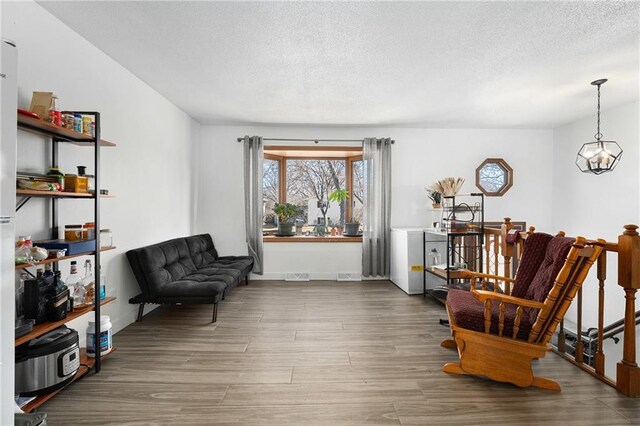 3374 Gerrard Ave, Eau Claire, WI 54701 - living area featuring baseboards, visible vents, wood finished floors, and a textured ceiling