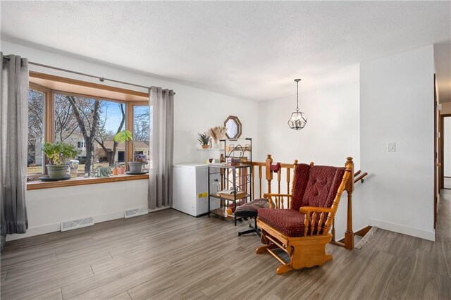 3374 Gerrard Ave, Eau Claire, WI 54701 - sitting room with baseboards, visible vents, wood finished floors, and a textured ceiling