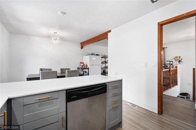 3374 Gerrard Ave, Eau Claire, WI 54701 - kitchen with light countertops, freestanding refrigerator, dishwasher, gray cabinetry, and light wood-style flooring