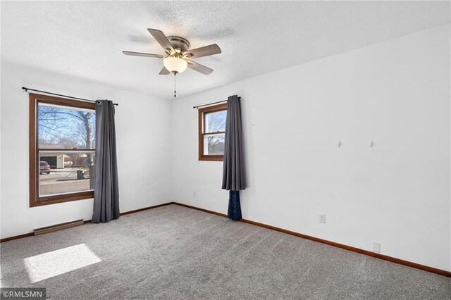 3374 Gerrard Ave, Eau Claire, WI 54701 - unfurnished room with carpet flooring, a textured ceiling, baseboards, visible vents, and ceiling fan