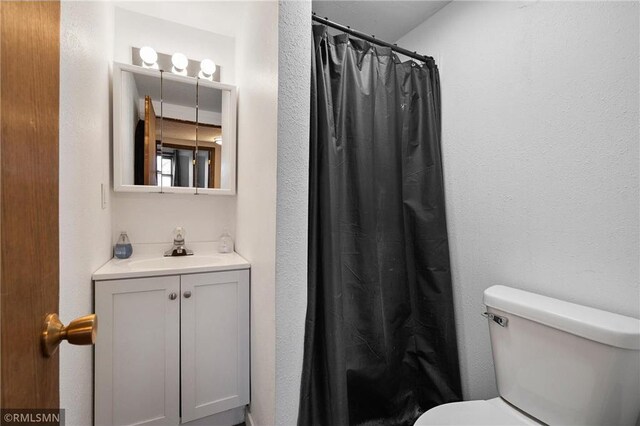 3374 Gerrard Ave, Eau Claire, WI 54701 - bathroom with toilet, vanity, and curtained shower