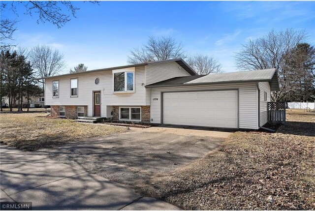 3374 Gerrard Ave, Eau Claire, WI 54701 - split foyer home with fence, an attached garage, and aphalt driveway
