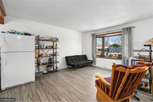 3374 Gerrard Ave, Eau Claire, WI 54701 - living area featuring visible vents, a textured ceiling, baseboards, and wood finished floors