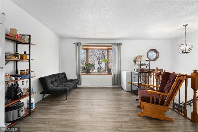 3374 Gerrard Ave, Eau Claire, WI 54701 - sitting room with baseboards, a chandelier, wood finished floors, and a textured ceiling