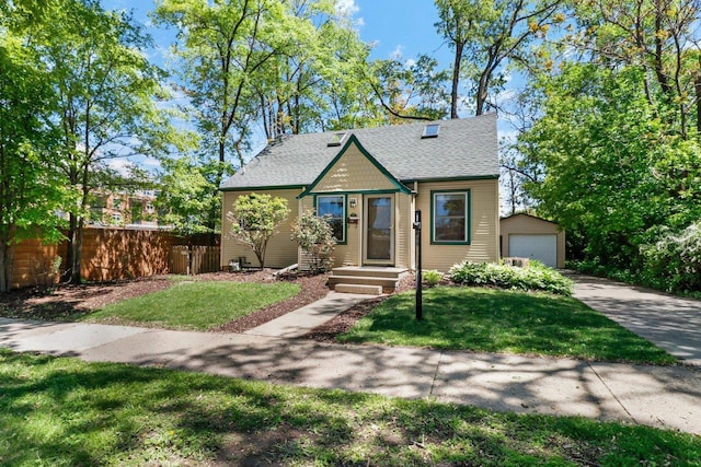 725 Eugenia Ave, Madison, WI 53705 - view of front of house featuring an outdoor structure, roof with shingles, a garage, and driveway