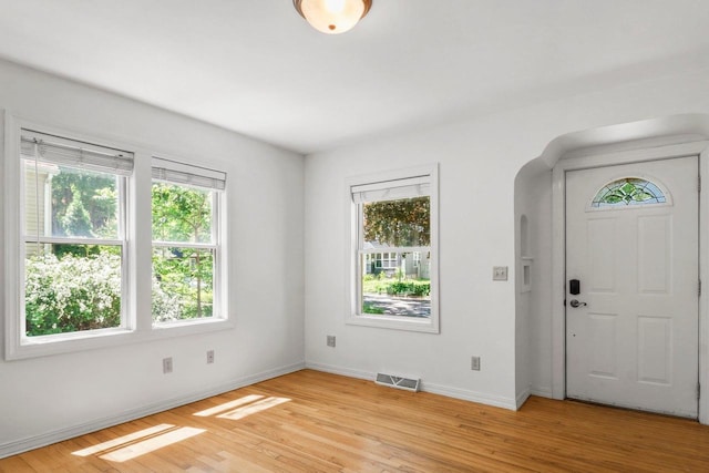 725 Eugenia Ave, Madison, WI 53705 - foyer with arched walkways, light wood-style flooring, and baseboards