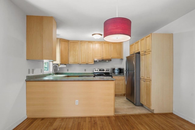 725 Eugenia Ave, Madison, WI 53705 - kitchen featuring stainless steel appliances, a sink, light brown cabinetry, light wood-style floors, and a peninsula