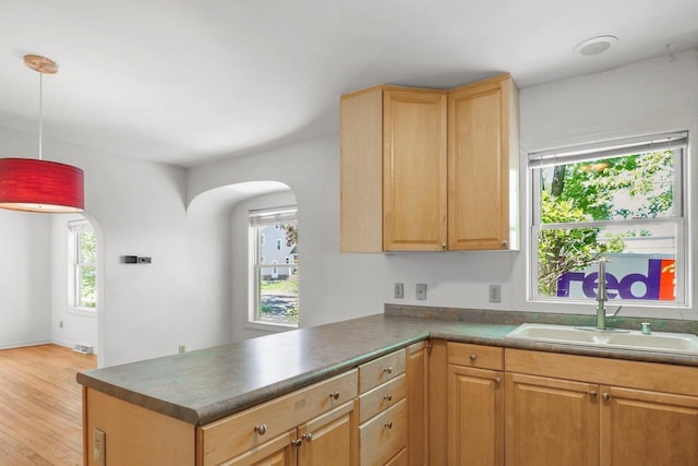 725 Eugenia Ave, Madison, WI 53705 - kitchen with a sink, healthy amount of natural light, and light wood finished floors