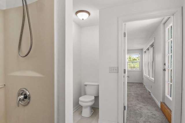 725 Eugenia Ave, Madison, WI 53705 - bathroom featuring toilet, a shower, and baseboards