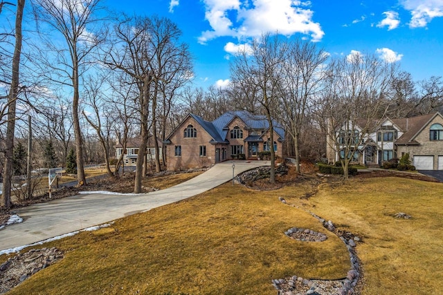 36082 N Beach Rd, Oconomowoc, WI 53066 - view of front of home featuring a garage, concrete driveway, and a front yard