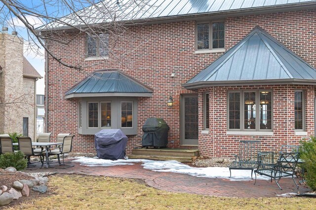 36082 N Beach Rd, Oconomowoc, WI 53066 - back of house with a patio, brick siding, and metal roof
