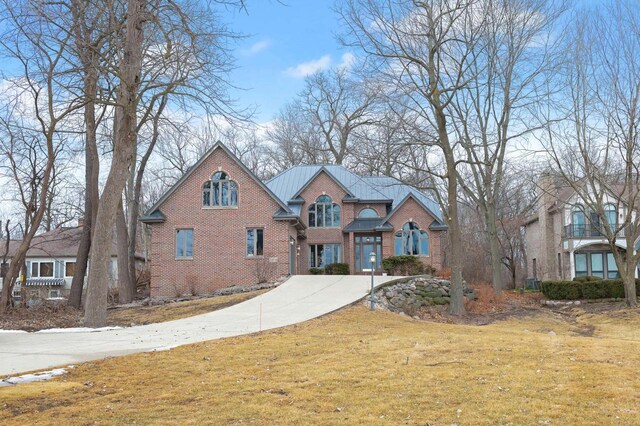 36082 N Beach Rd, Oconomowoc, WI 53066 - view of front of property with driveway, a front yard, and brick siding