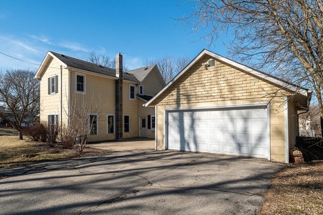 view of home's exterior featuring driveway and an attached garage