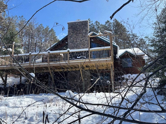 14005 W Riverside Rd, Lakewood, WI 54138 - snow covered rear of property featuring a chimney and a deck