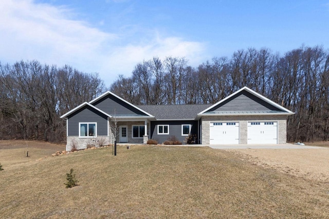 W4668 Reetz Rd, Princeton, WI 54968 - view of front of home featuring a front yard, an attached garage, stone siding, and dirt driveway