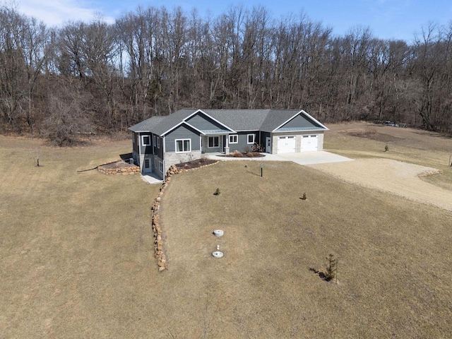 W4668 Reetz Rd, Princeton, WI 54968 - single story home featuring driveway, a garage, stone siding, and a front yard