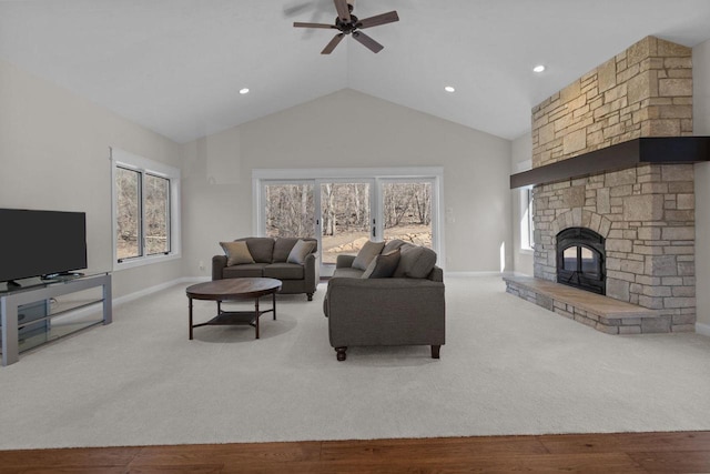 W4668 Reetz Rd, Princeton, WI 54968 - carpeted living room featuring a ceiling fan, baseboards, a stone fireplace, high vaulted ceiling, and recessed lighting