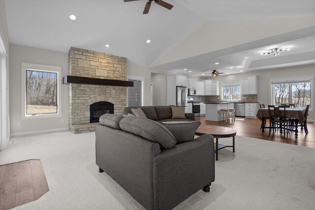 W4668 Reetz Rd, Princeton, WI 54968 - living area with ceiling fan, light colored carpet, a stone fireplace, recessed lighting, and baseboards