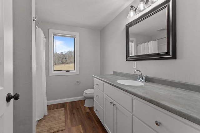 W4668 Reetz Rd, Princeton, WI 54968 - bathroom with vanity, wood finished floors, baseboards, and toilet