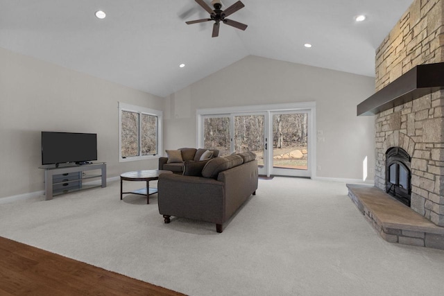 W4668 Reetz Rd, Princeton, WI 54968 - living room featuring ceiling fan, a stone fireplace, baseboards, high vaulted ceiling, and plenty of natural light